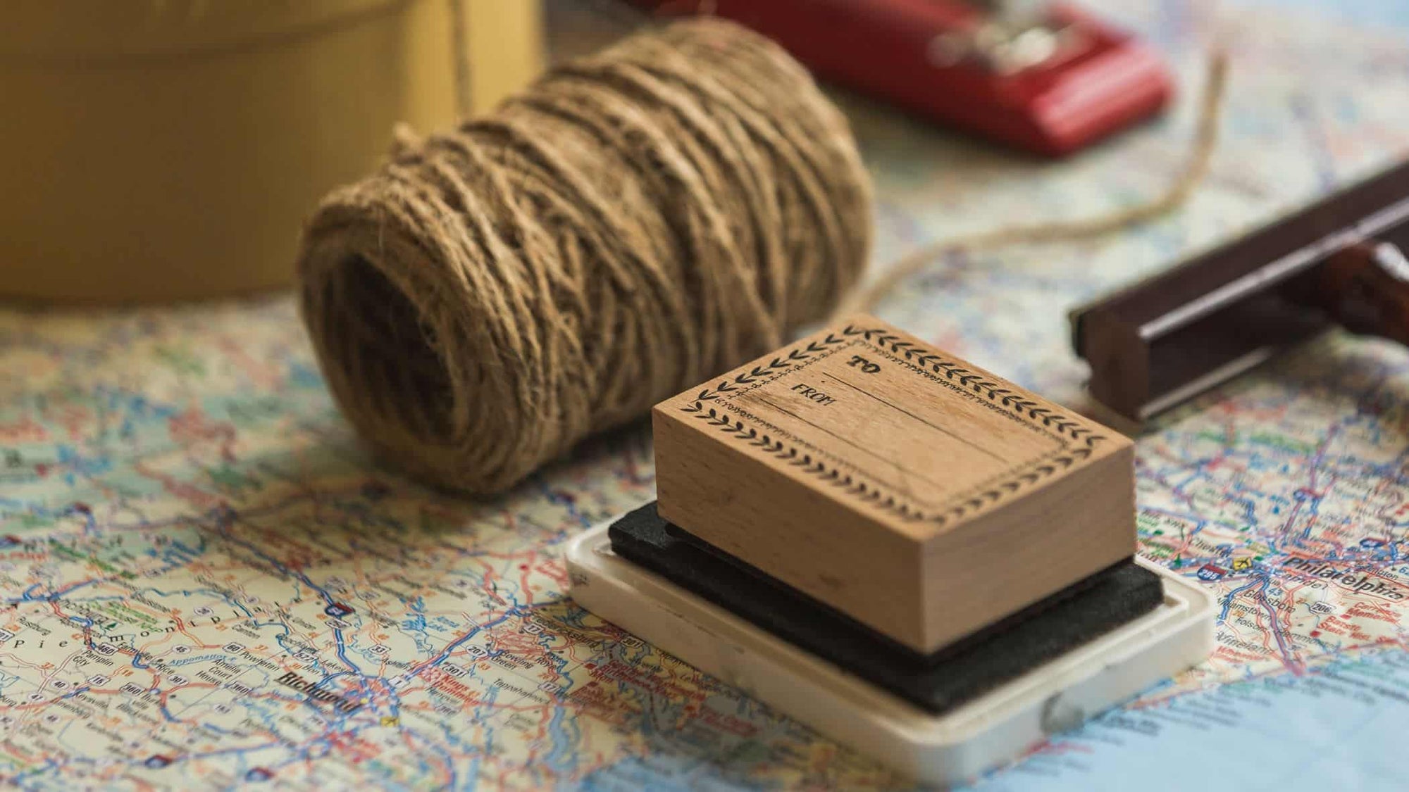 stamp and twine on a map