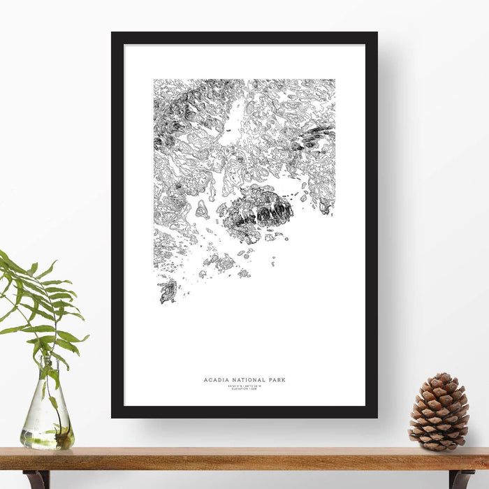 National park print of Acadia with black and white topography in a black 24x36 vertical frame.