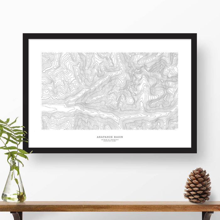 Framed travel art of Arapahoe Basin, featuring topography map art in black and white.
