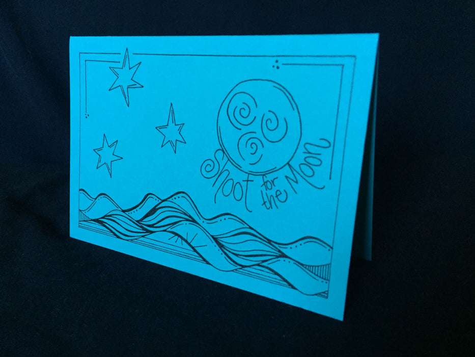 Card features design of the night sky above water along with the words shoot for the moon.