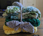 Photograph of the kitchen towels folded up, stacked on top of each other, and tied together.