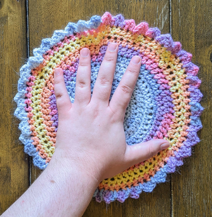Photograph of the altar cloth with the creator's hand on it, for scale.