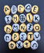 Photograph of a set of Greek Alphabet Oracle stones painted in gold and silver.