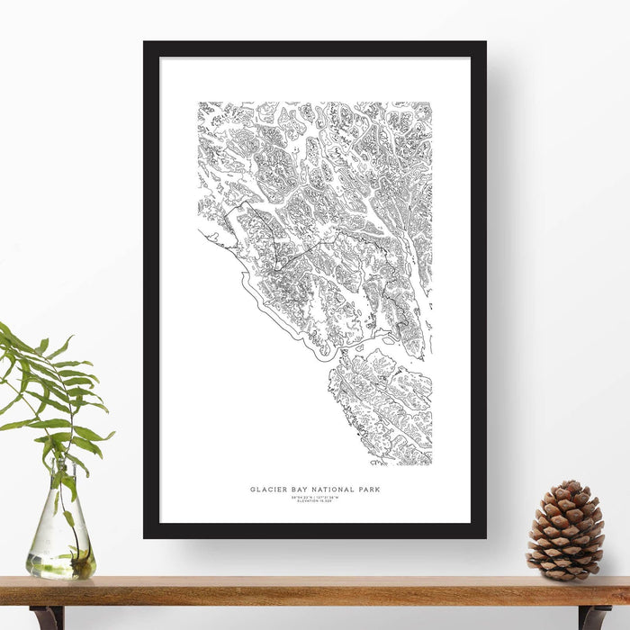 National park print of Glacier Bay with black and white topography in a black 24x36 vertical frame.