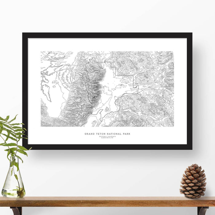 Framed black and white print of Grand Teton National Park topography art. Text can be added to create a custom map poster as a travel gift.