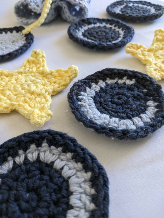 Close-up photograph of cotton face scrubbies that look like stars and moons.