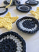 Close-up photograph of cotton face scrubbies that look like stars and moons.