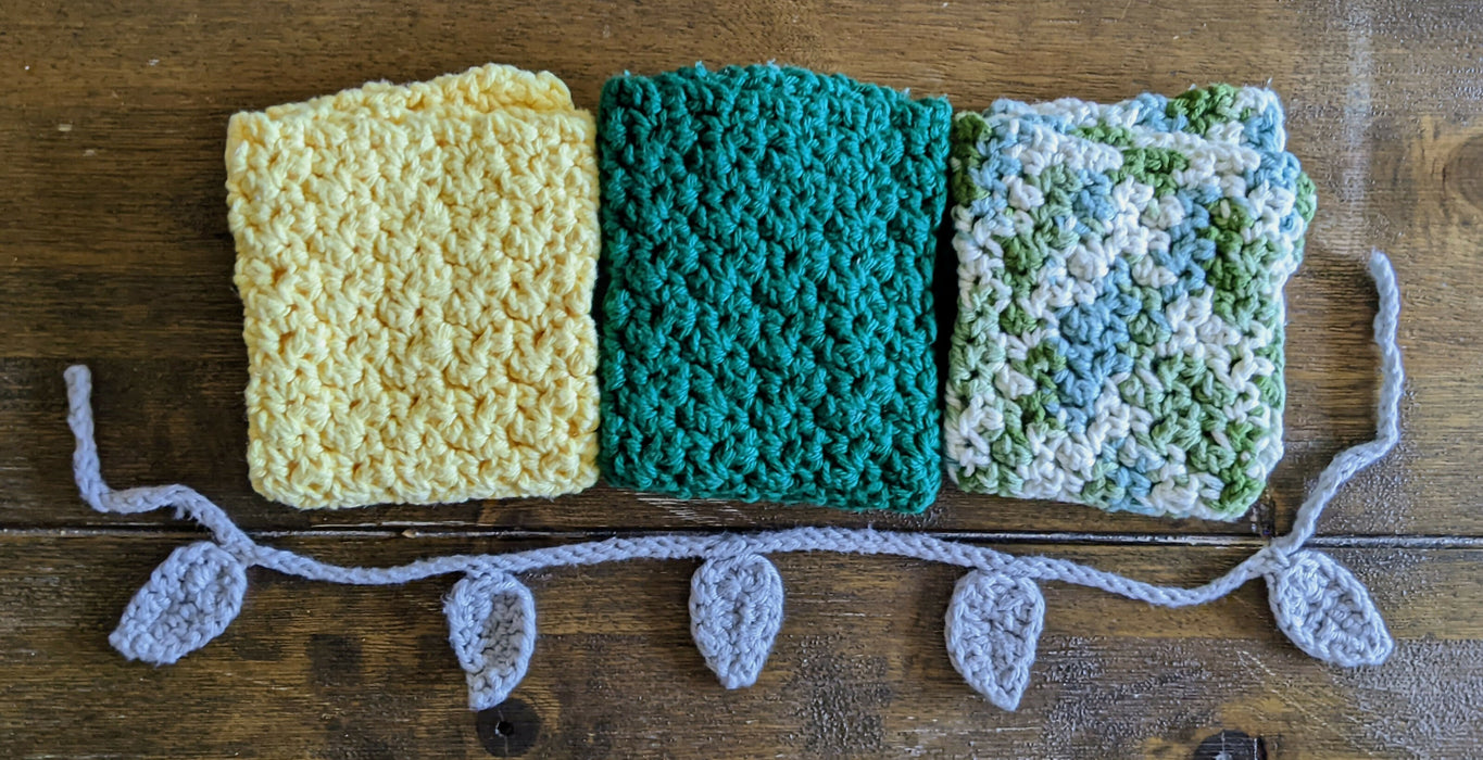 Photograph of the three kitchen towels folded up and placed next to each other, alongside the tie.