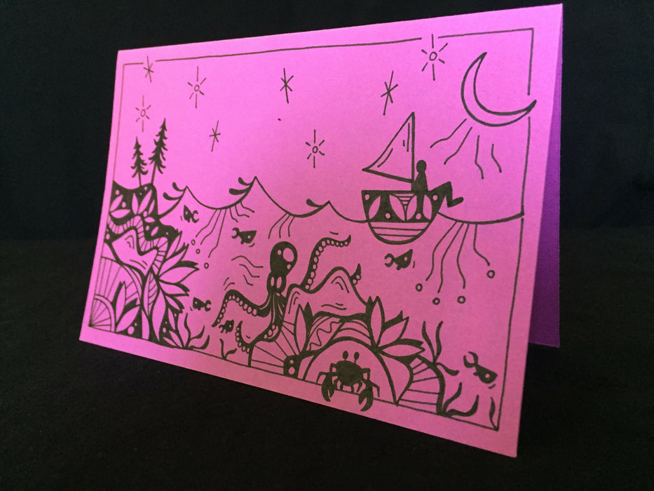 Card features an octopus, crab, and fish swimming below a person on a sailboat under a star-filled night sky on lilac-colored paper.
