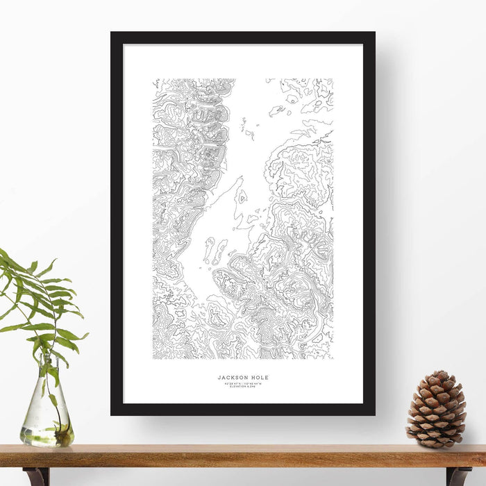 Topography map print print of Jackson Hole, Wyoming with black and white topography in a black 24x36 vertical frame.