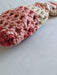 Close-up photograph of the pink and brown bag.