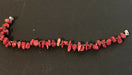 Beaded bracelet consisting of alternating red coral chip beads and metallic multicolored glass seed beads