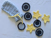 Photograph of a set of face scrubbies that look like stars and moons, with their matching bag.