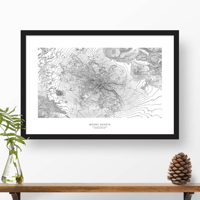 Map wall decor in a black frame. Contour lines of Black Elk Peak, South Dakota are drawn on a white background. Text  below the map can be customized to create custom adventure art.