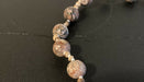 Close-up image of necklace showing the mottled pattern on the stone beads in detail.