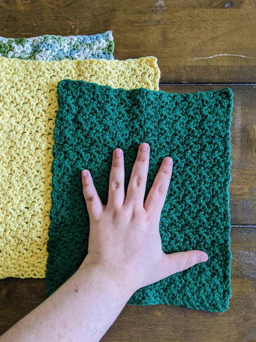 Photograph of the unfolded kitchen towels with the creator's hand on them, for scale.
