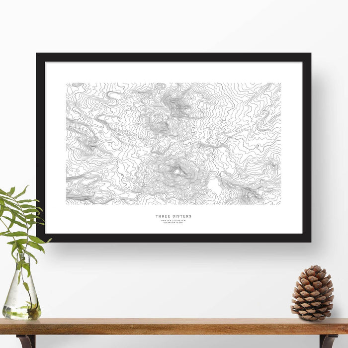 Framed black and white print of Three Sisters, Oregon topography art. Text can be added to create a custom map poster as a travel gift.
