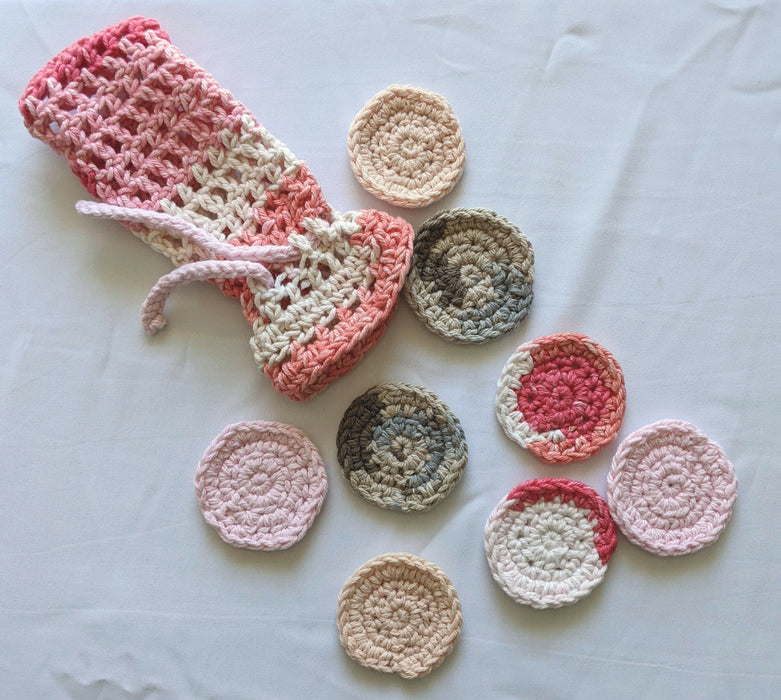 Photograph of a pink and brown set of face scrubbies with their matching bag.