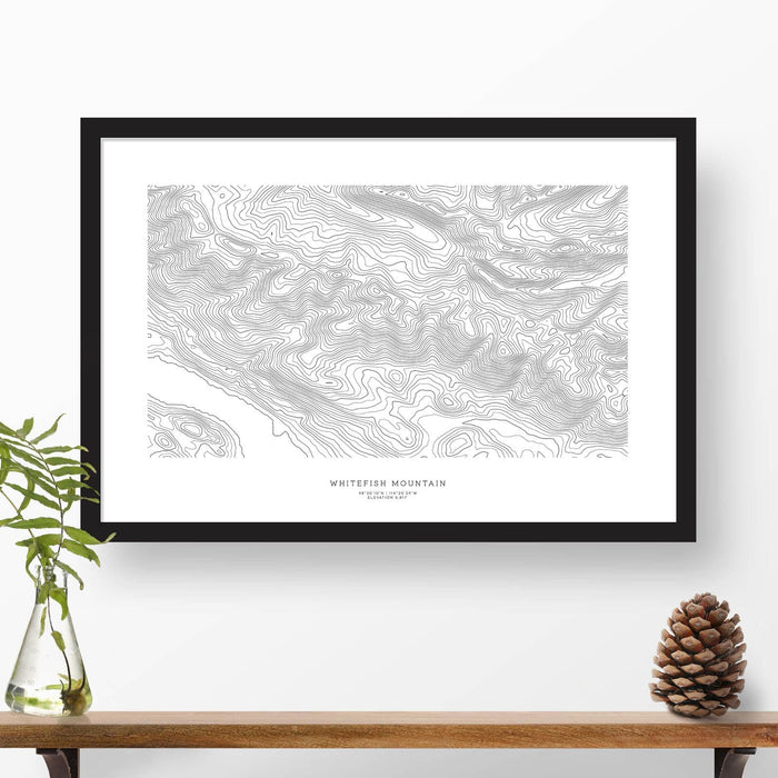 Framed black and white print of Whitefish Mountain, Montana topography art. Text can be added to create a custom map poster as a travel gift.