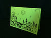 Card features evening nature scene with trees, fish, crabs, and a house on lime green paper.
