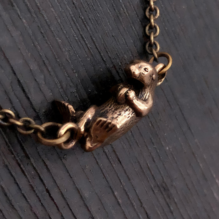 Floating Otter Necklace – Handcrafted Bronze Otter Pendant With Claw Clasp
