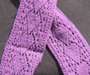 close up of the arrow motif on a narrow purple scarf