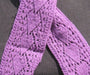 close up of the arrow motif on a narrow purple scarf