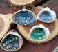 This shows 4 styles of the resin Ocean shells sitting on a wood slab.