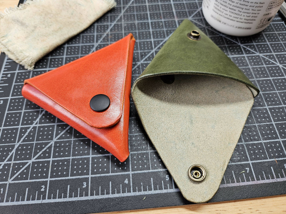 2 of the pouches from the previous picture - orange and olive green - with the flap on the olive green one open to show the inside.