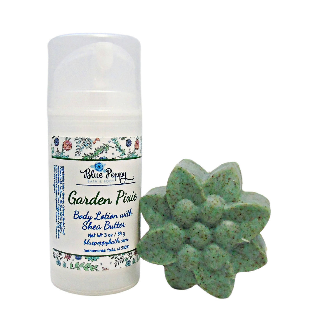 Handmade body lotion and soap set with the name Garden Pixies on the label and a green flower-shaped bar of soap with flecks of brown exfoliating walnut shell