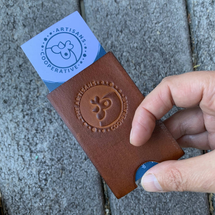 Honey leather business card case with the ARtisans Cooperative logo