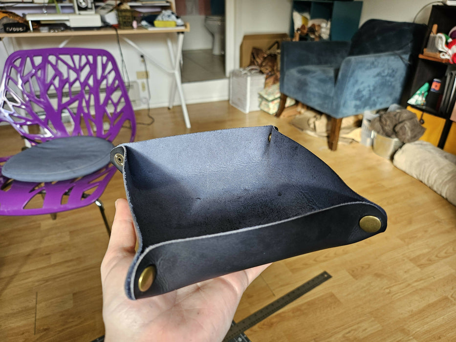 the tray sits on a hand. The inside is the fuzzy side of the leather, and the outside the finished side.