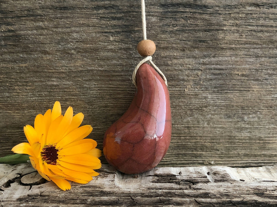 Calming worry pendant (red-orange) w/ sandalwood in raku ceramic