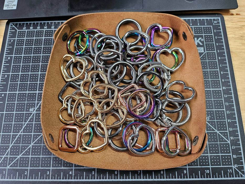 the brown leather tray holding many various o-rings