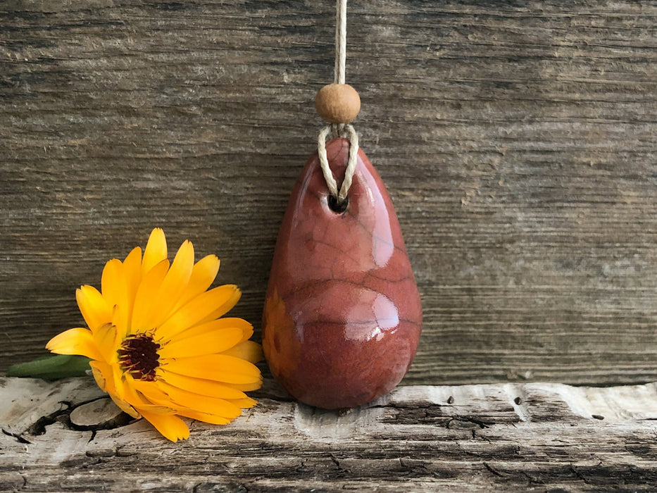 Calming worry pendant (red-orange) w/ sandalwood in raku ceramic