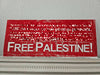 a pixelated image of a print in red ink with all but the words Free Palestine blurred out